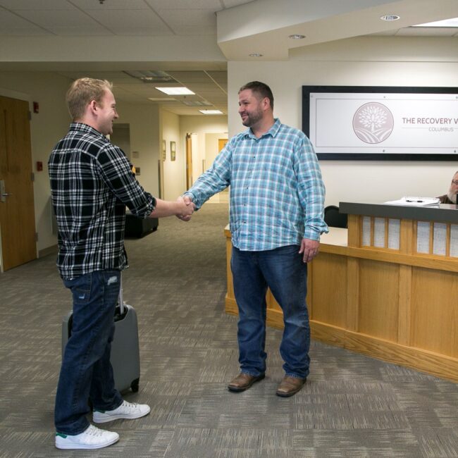 Two men shaking hands in an office