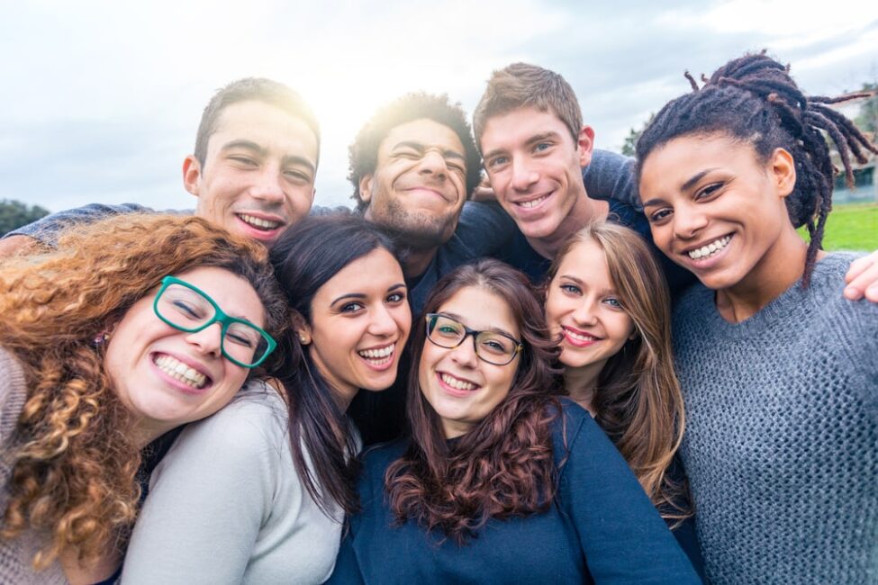 A diverse group of young people smiling together in a joyful moment